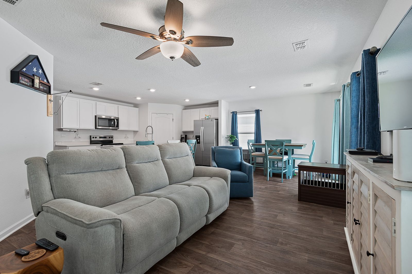 Bright open-concept living area with luxury vinyl plank flooring